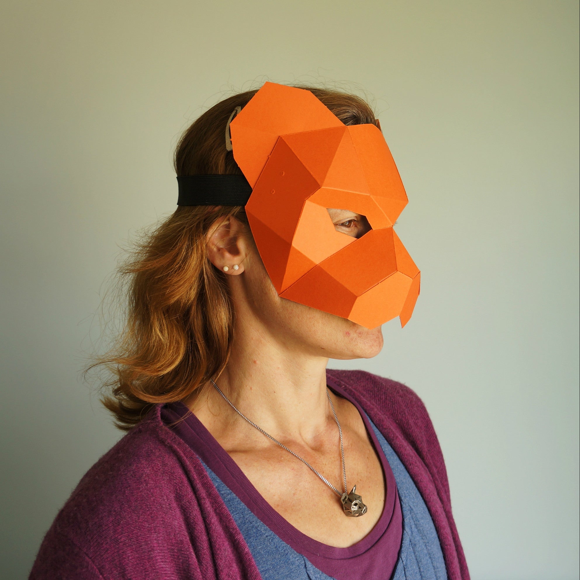 Women wearing a card tiger mask