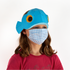 Child wearing a blue fish-shaped hat and checkered mask on a white background