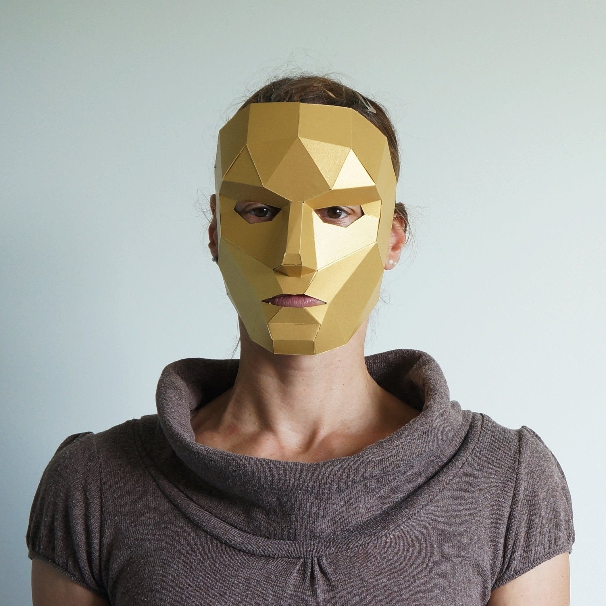 women in a gold card mask