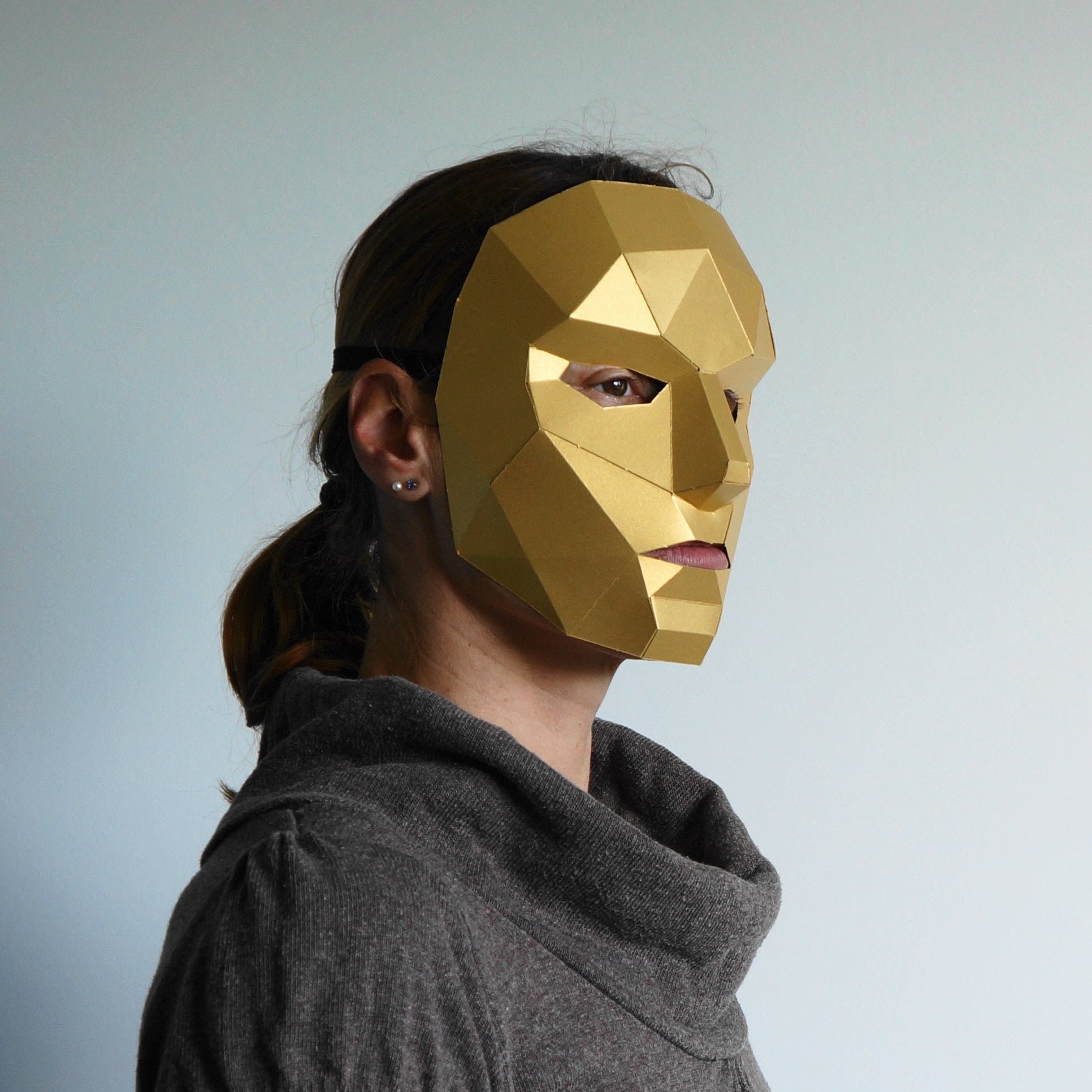 women in a gold card mask