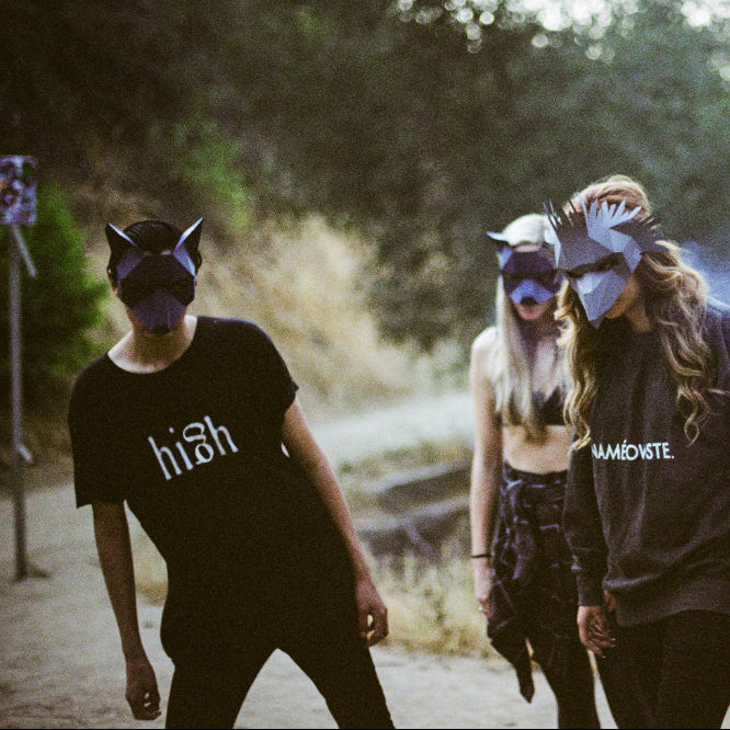Group of people wearing Low-Poly animal masks and hoodies outdoors